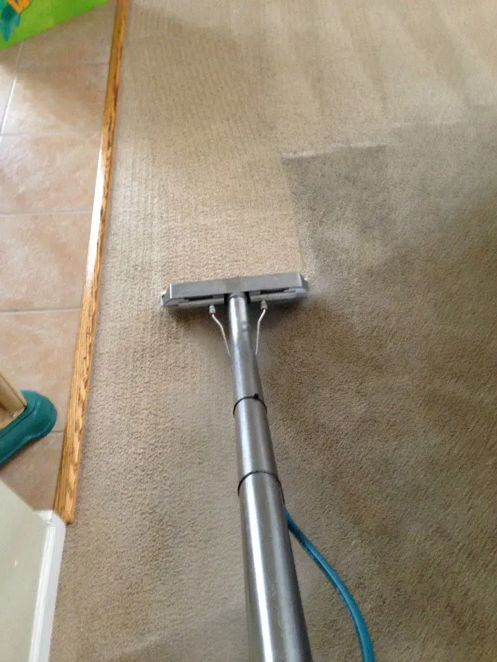 A carpet cleaning machine is being used to clean the floor.