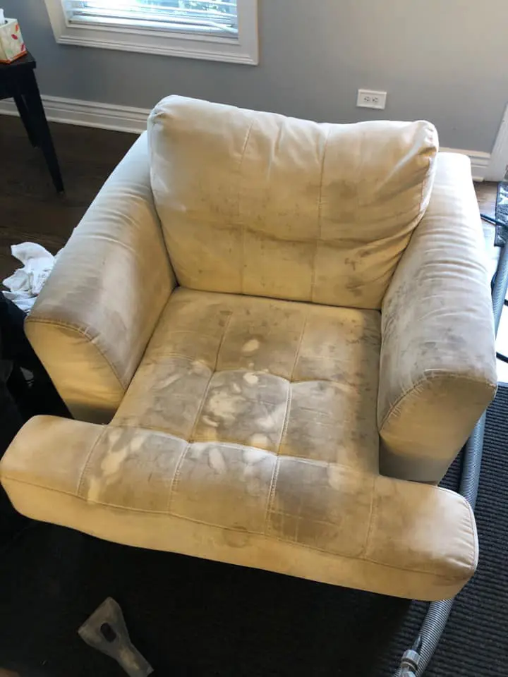 A white chair with a stain on it