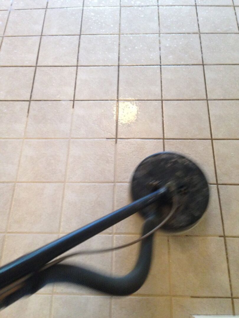 A floor cleaning machine is on the tile floor.