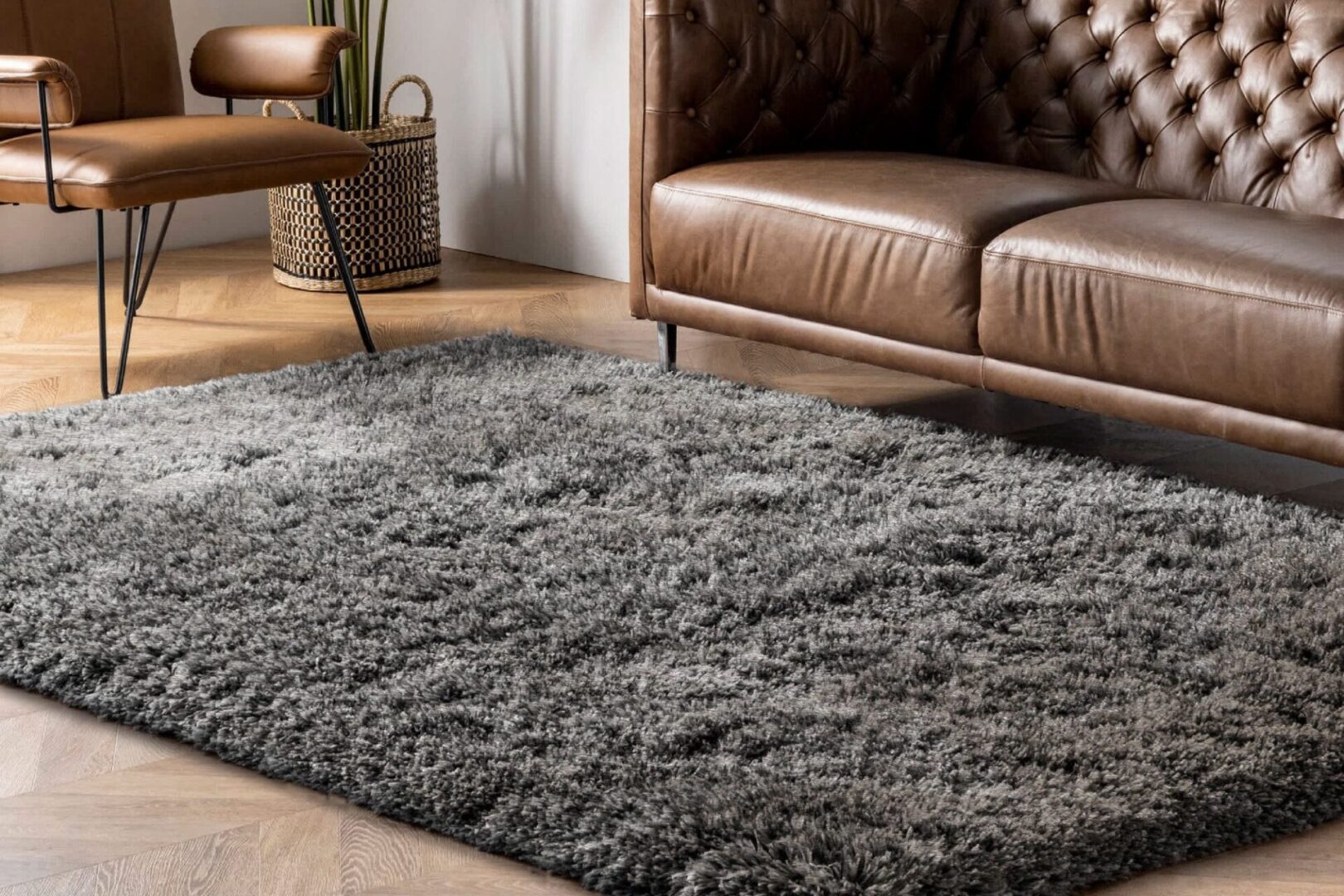 Cozy gray shag rug under a leather sofa in a modern living room.