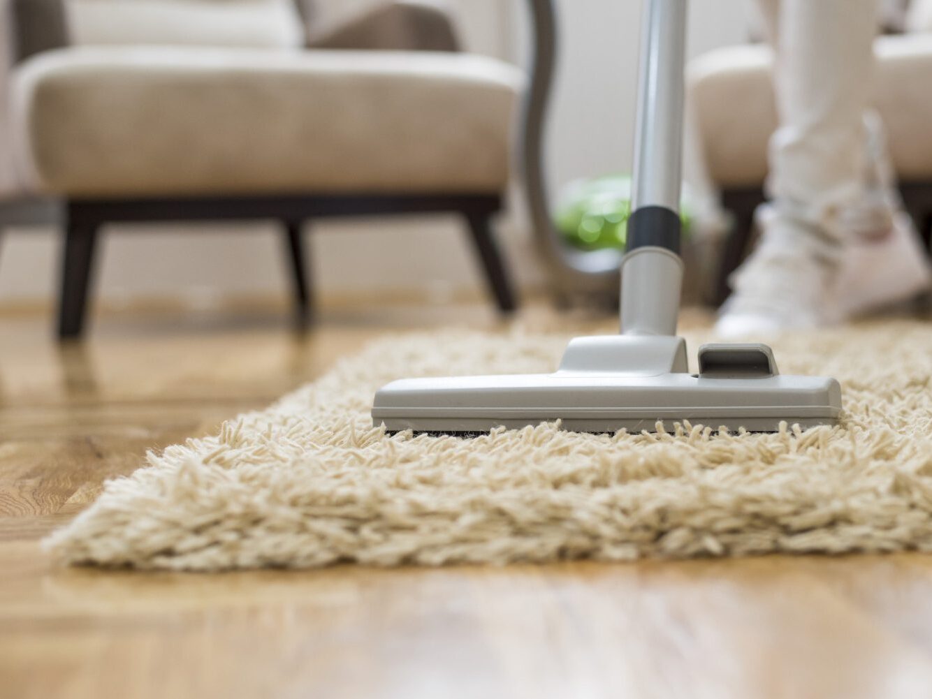 Hand touching soft, textured carpet fibers.